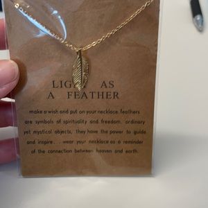 Gold tone feather necklace